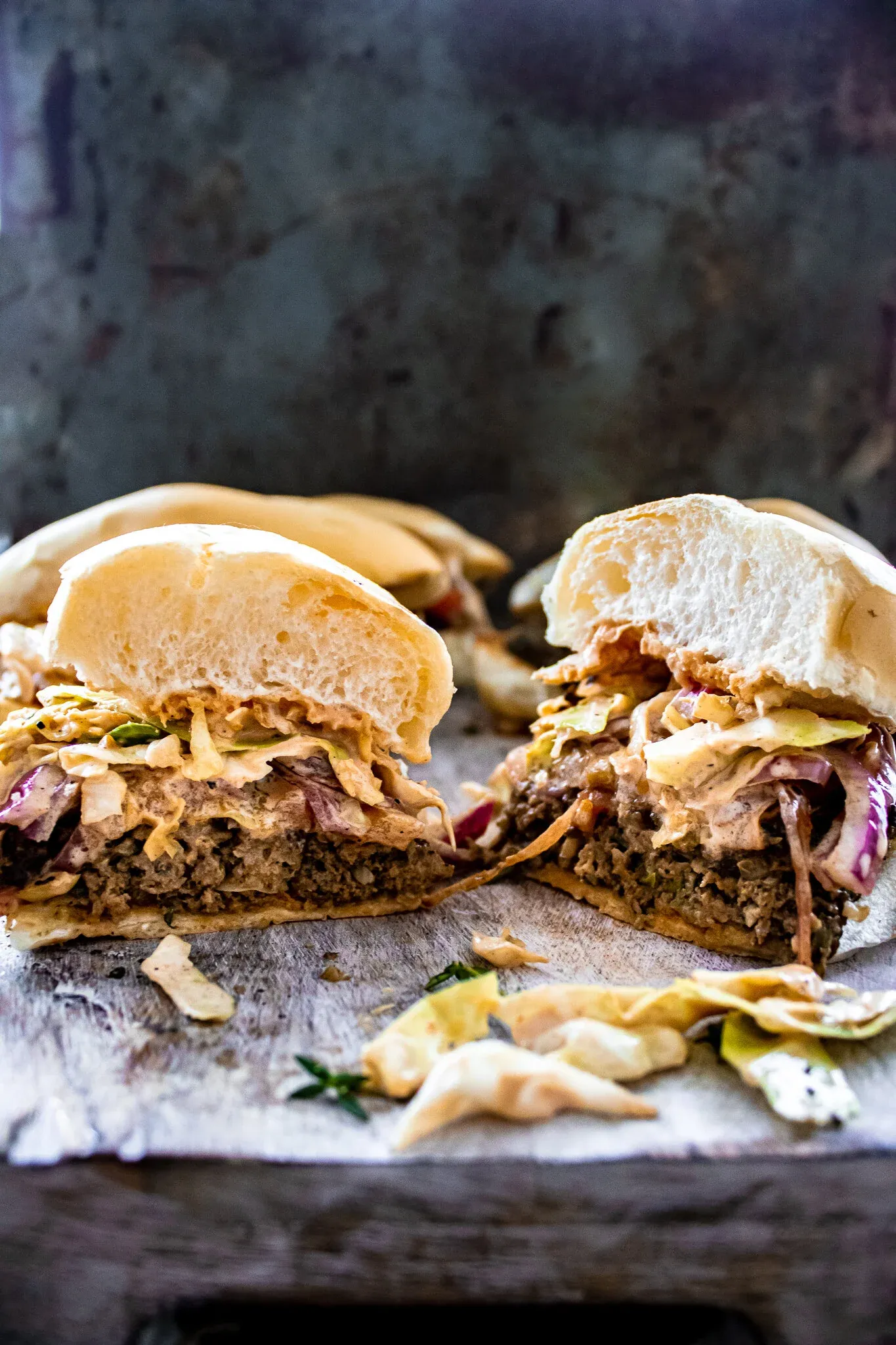Dominican Chimi Burger cut in half and presented cut-side facing forward