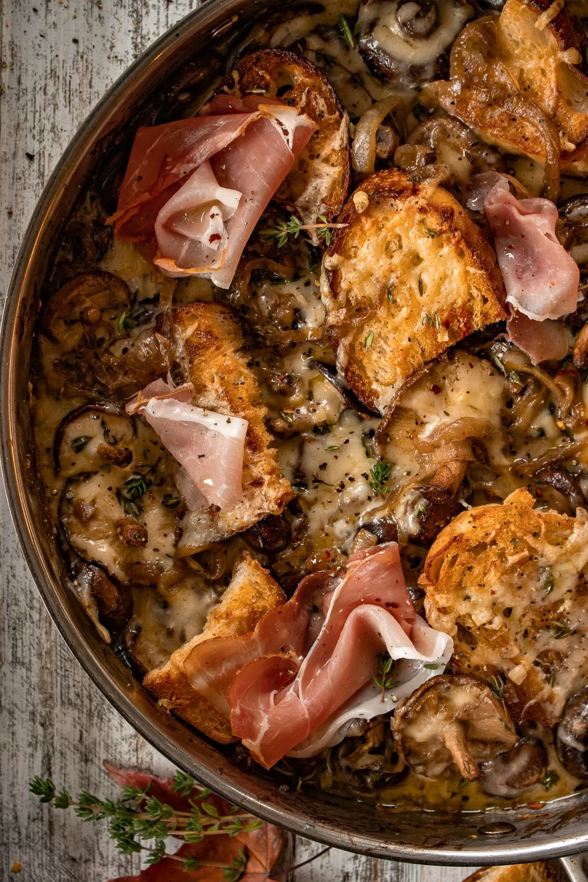 Close-up angled shot of French Onion Mushrooms in a stainless pan
