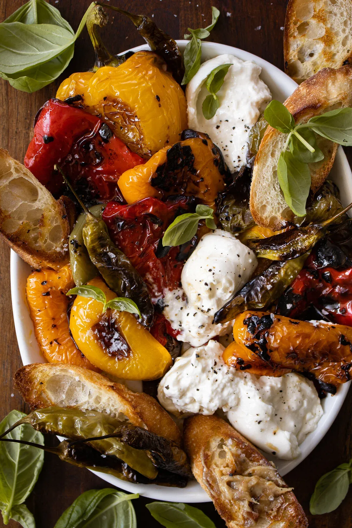 Closer overhead angle of the Roasted Peppers with Burrata platter, highlighting the deeply charred red, yellow