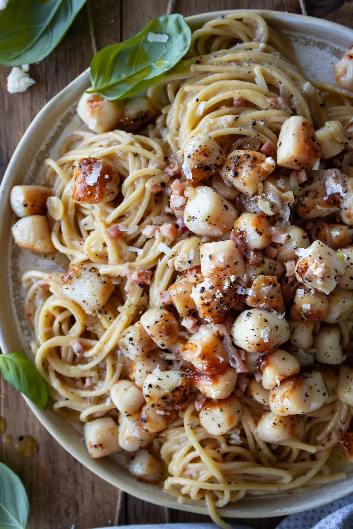 Close-up overhead shot of the Garlic Butter Pasta with Seared Scallops plate, zoomed in to show the texture