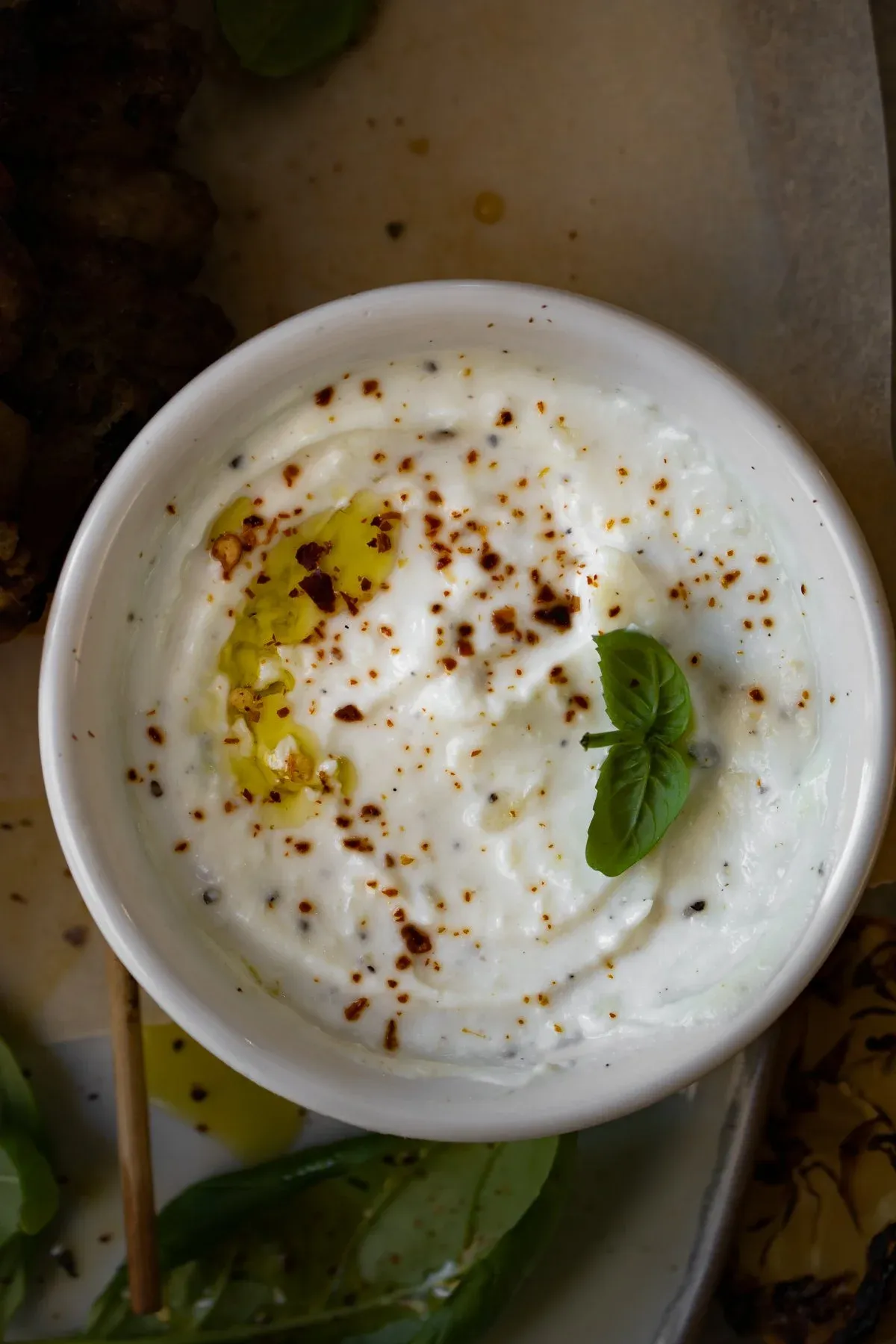 Close-up overhead of the garlicky whipped ricotta dipping bowl, smooth