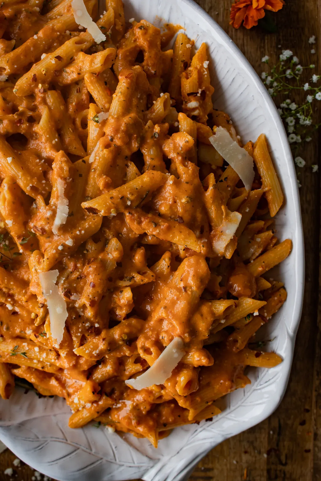 Angled close-up of the pasta alla vodka on the white oval platter from a slightly lower perspective