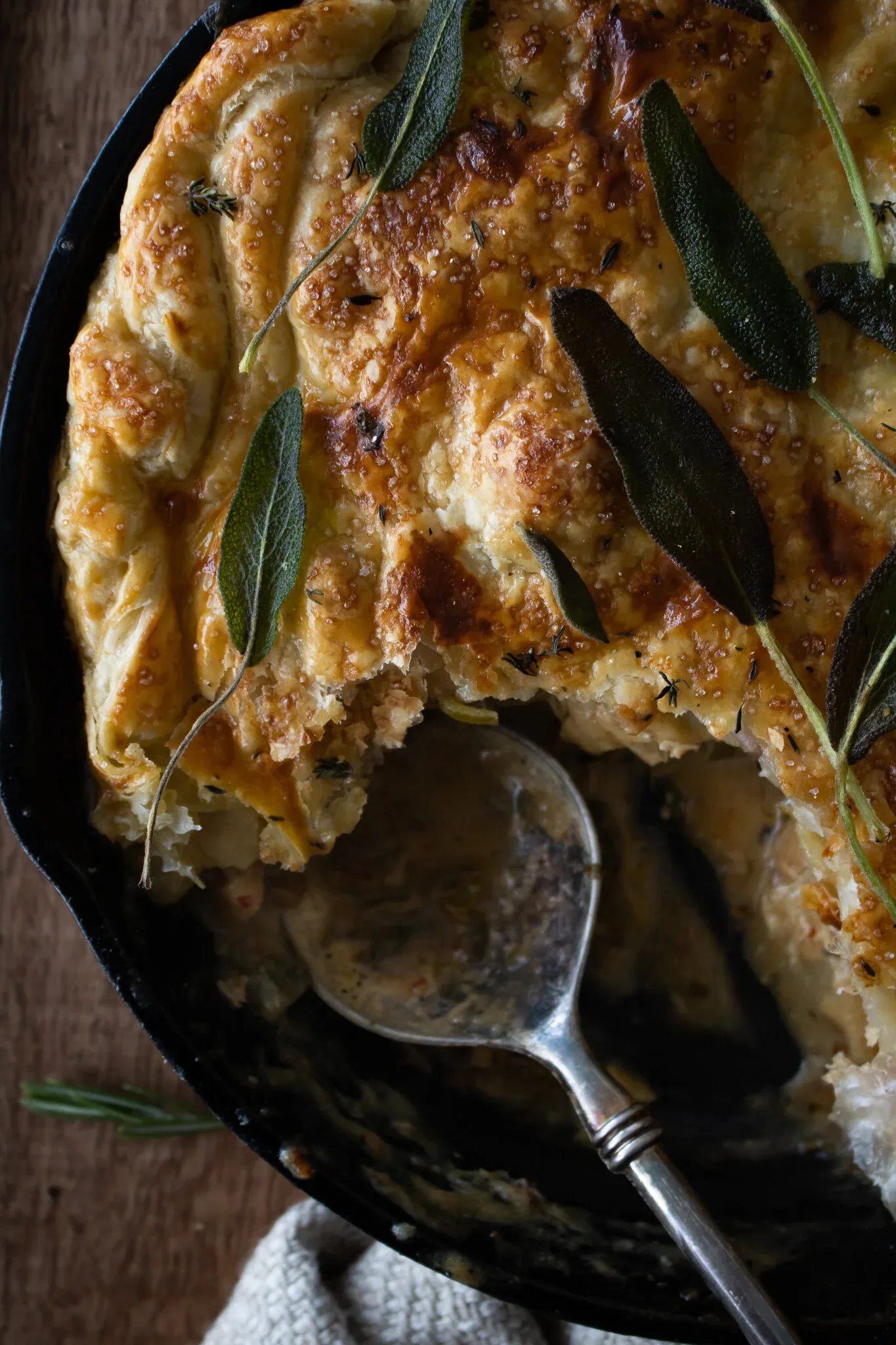 Angled close-up of the chicken pot pie in the cast iron skillet from slightly