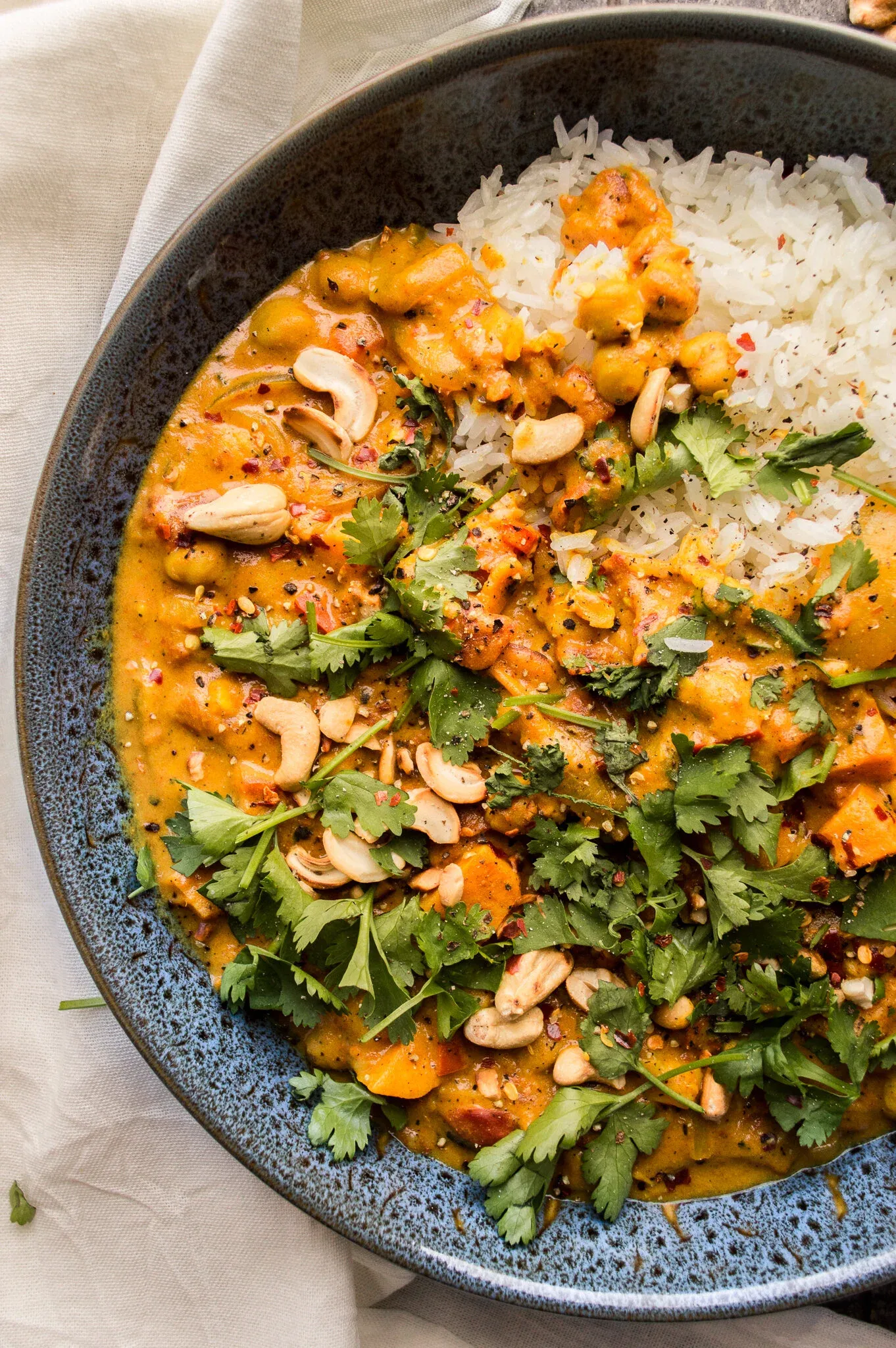 Close-up overhead detail of the Chickpea and Sweet Potato Stew in a blue speckled ceramic bowl