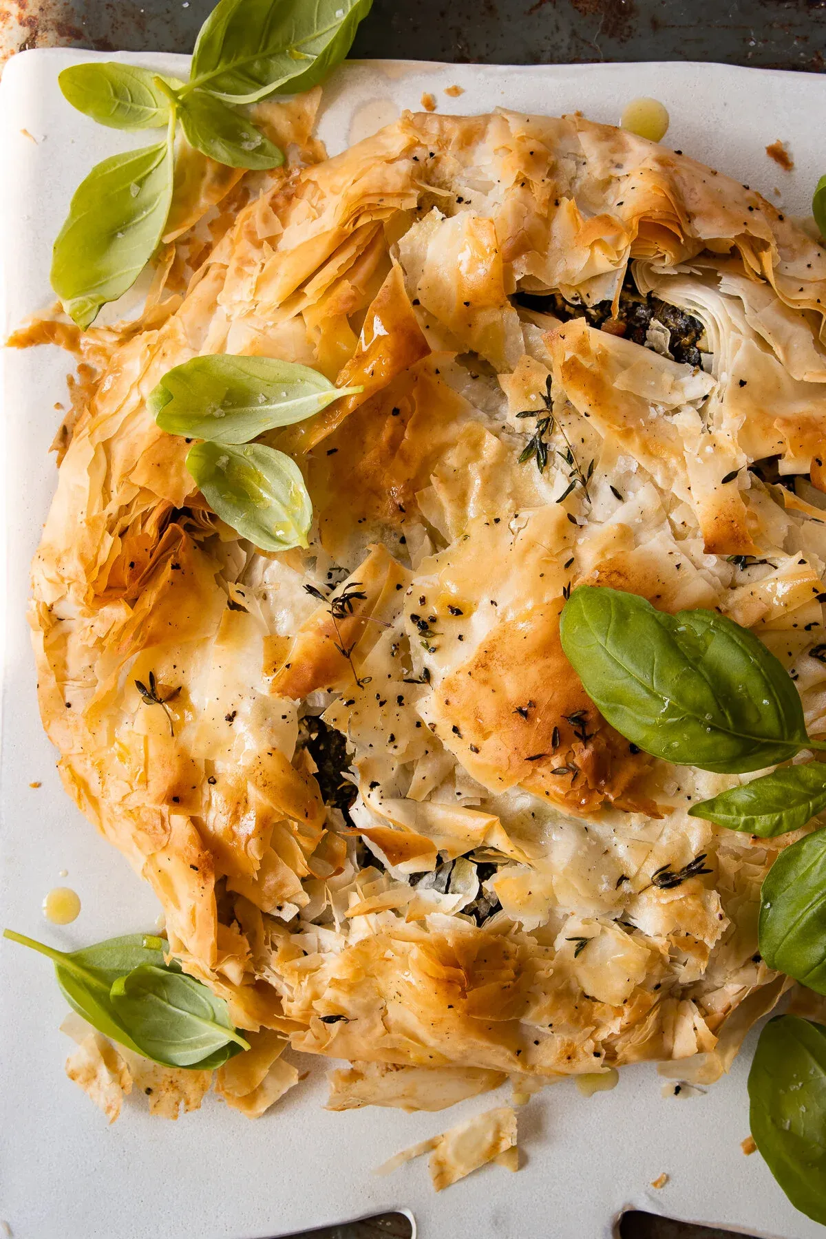Angled overhead view of the Spinach and Feta Phyllo Pie on a white surface, slightly cropped
