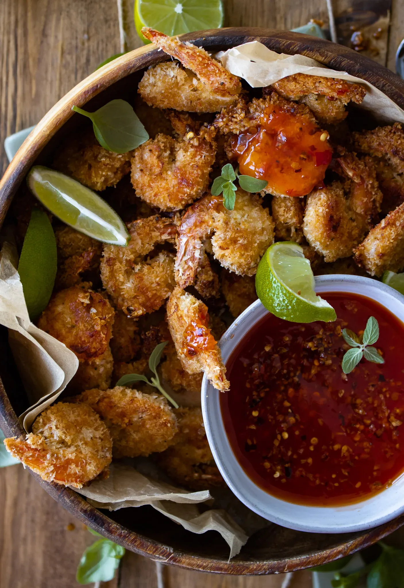 Closer overhead angle of the wooden bowl of coconut crusted shrimp