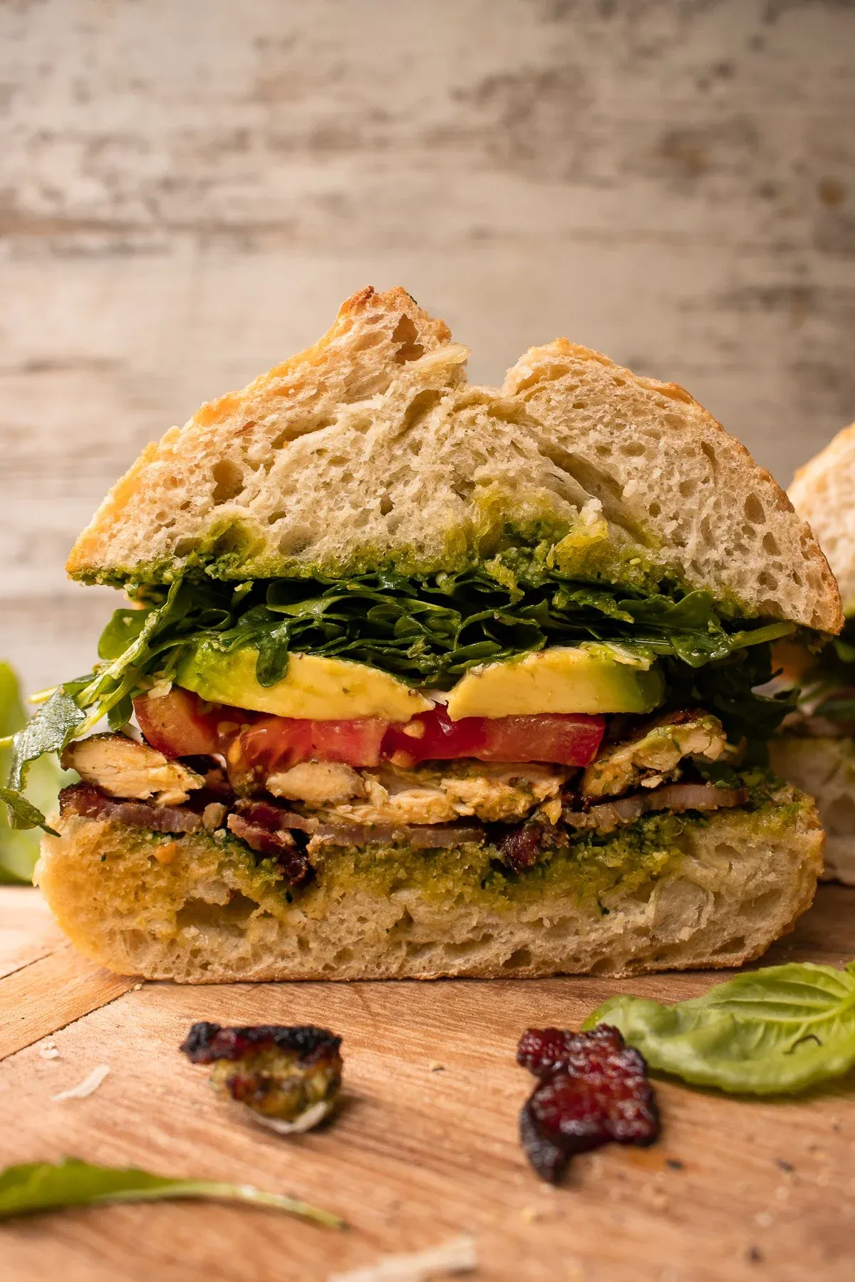 Cross-section view of the Pesto Chicken BLT Sandwich cut in half and stood on its side