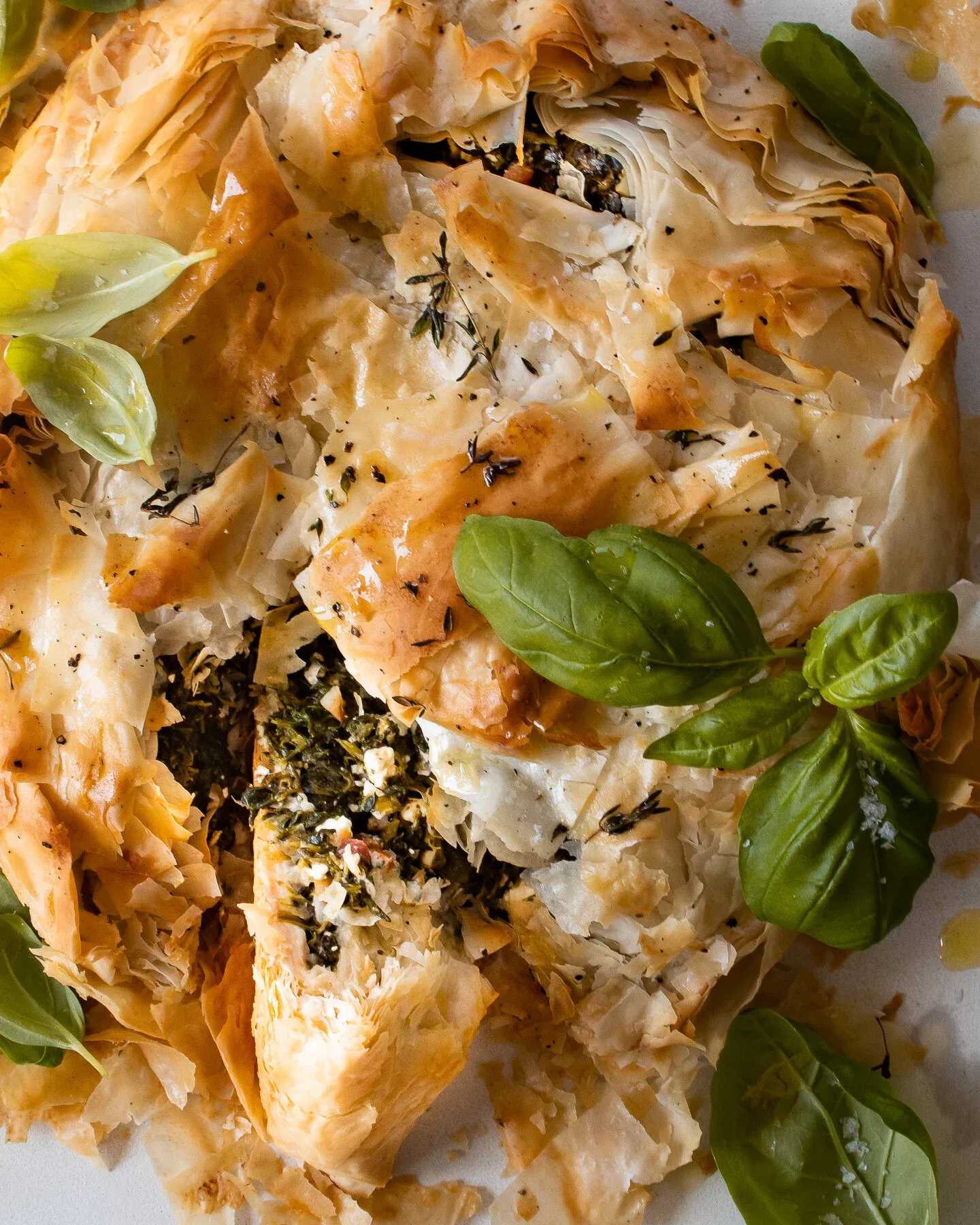 Very close overhead crop of the Spinach and Feta Phyllo Pie on a white surface