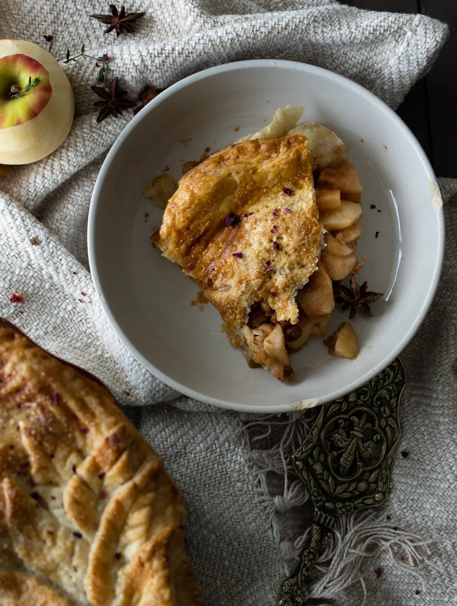 Overhead view of a single slice of Classic Apple Pie served in a round white bowl