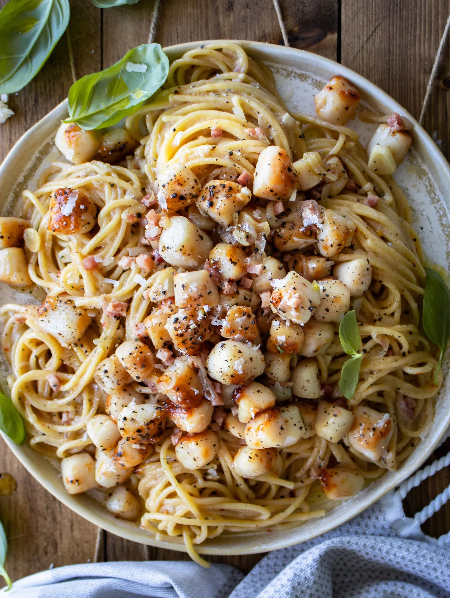 Overhead view of the full cream ceramic plate of Garlic Butter Pasta with Seared Scallops from a slightly elevated angle