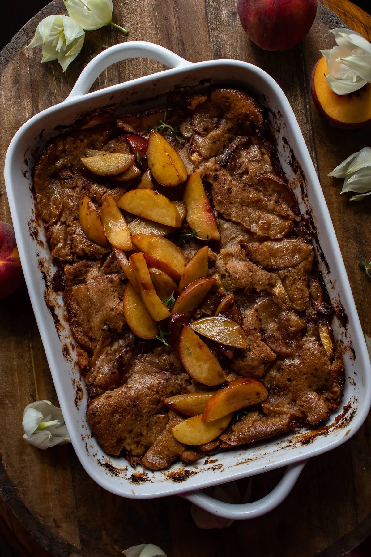 Overhead view of Brown Butter Peach Cobbler in a white rectangular handled baking dish