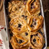 Overhead shot of Blueberry Phyllo Milk Pie baked in a white rectangular dish with handles