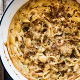 Creamy 7 Cheese Herb and Garlic Baked Mac and Cheese fresh from the oven in a white enamel Dutch oven