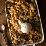 Short Rib Beecher's Mac and Cheese with Burrata served in a white rectangular ceramic baking dish with handles