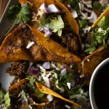 Close overhead shot of Not Birria Beef Tacos piled on a metal baking tray