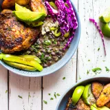 Two gray ceramic bowls of Mojito Inspired Chicken Bowls shot overhead on a distressed white wood surface