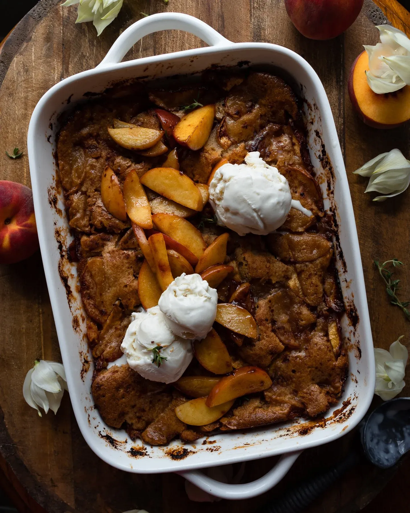Overhead view of Brown Butter Peach Cobbler in a white rectangular handled baking dish