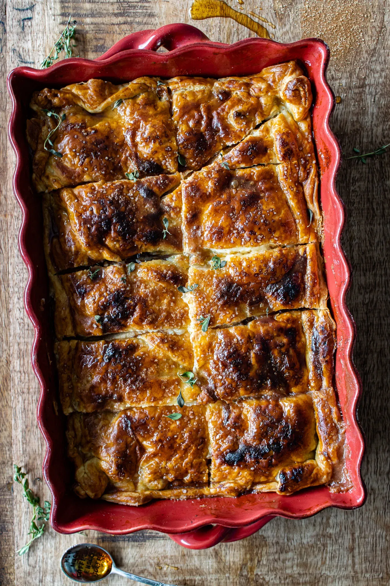 Apple and Bourbon Pandowdy just out of the oven in a red scalloped ceramic baking dish