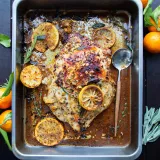 Overhead view of Herby Wine and Citrus Marinated Turkey Breast freshly roasted in a stainless steel rectangular roasting pan