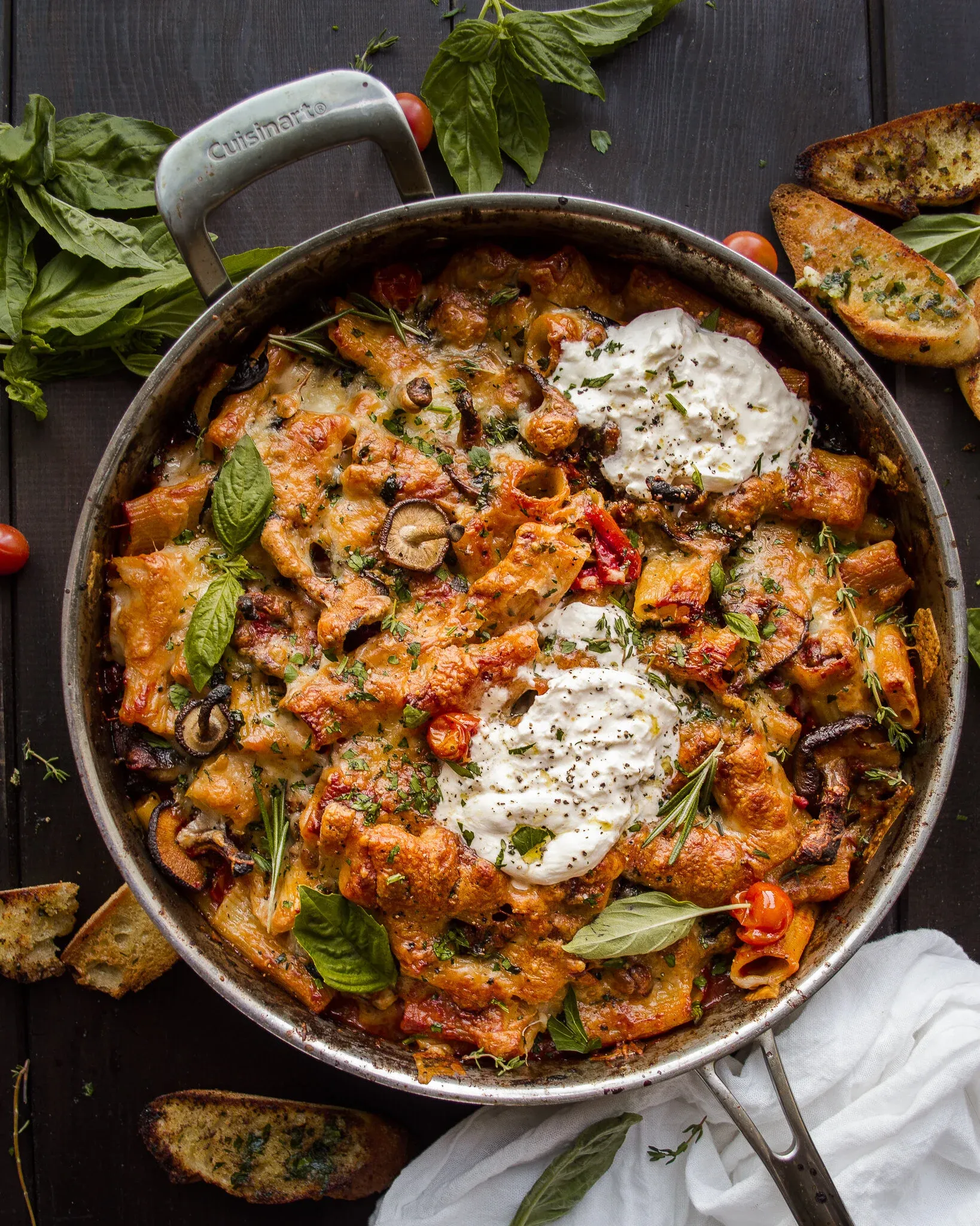 Overhead view of Cheesy One-Pot Roasted Red Pepper and Tomato Pasta in a large Cuisinart stainless skillet on a dark wood surface