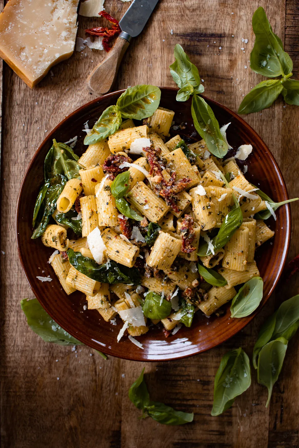 30 Minute Basil Pasta with Sun-Dried Tomatoes in a terracotta ceramic bowl