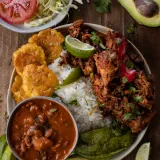 La Bandera Dominicana traditional Dominican lunch in a wide ceramic bowl — fluffy white rice