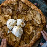 Pear and Mascarpone Thyme Galette on a decorative teal patina embossed metal charger plate on dark wood