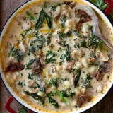 Overhead view of One Pot Gnocchi Soup with Kale and Prosciutto in a large red-handled white enamel braiser