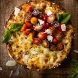 Overhead view of a Rigatoni Pasta Pie on a rustic wooden cutting board