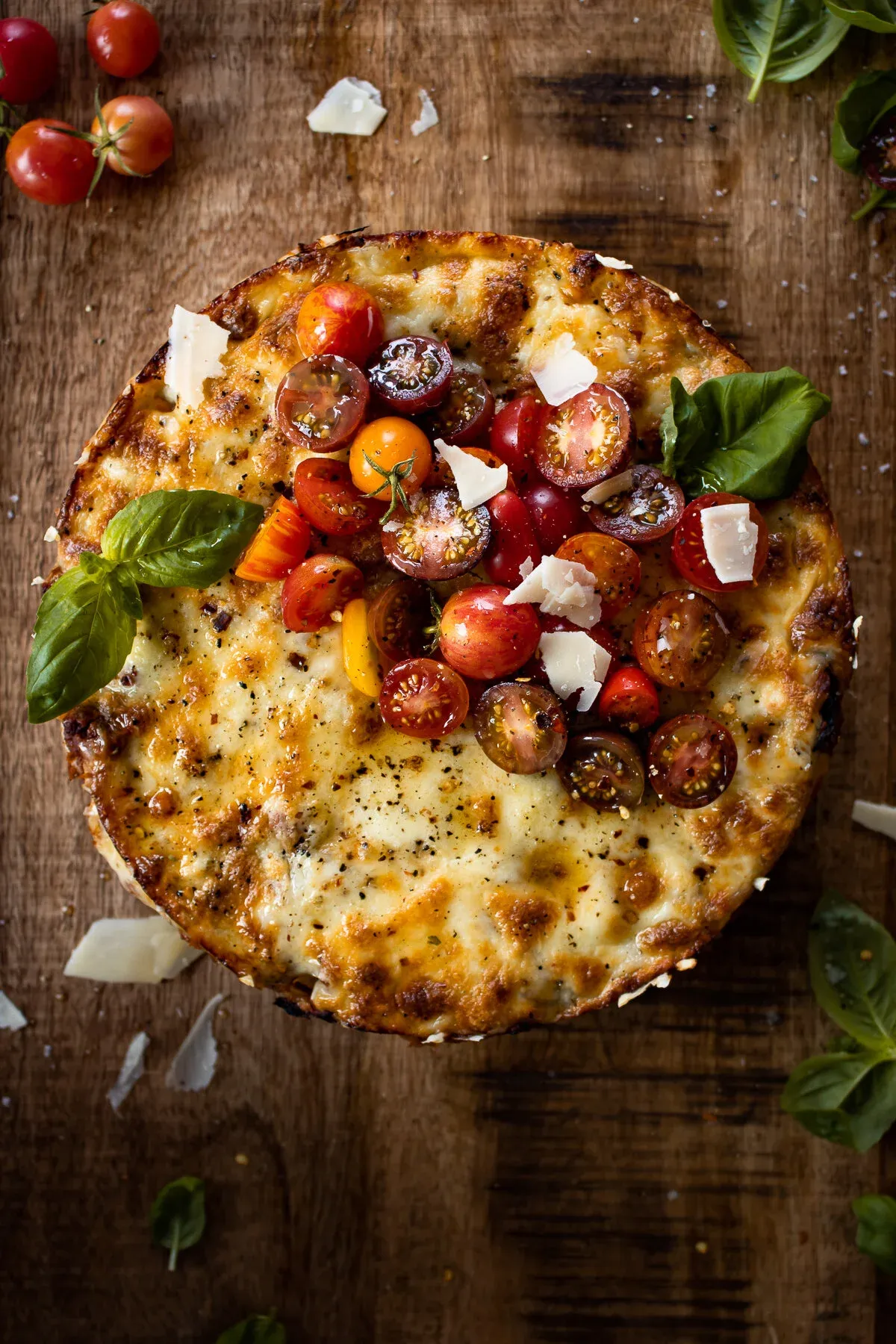 Overhead view of a Rigatoni Pasta Pie on a rustic wooden cutting board